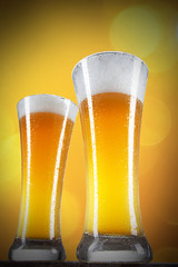 Beer in a glasses with gold background