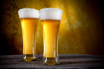 Beer in a glasses with gold background