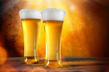 Beer in a glasses with gold background