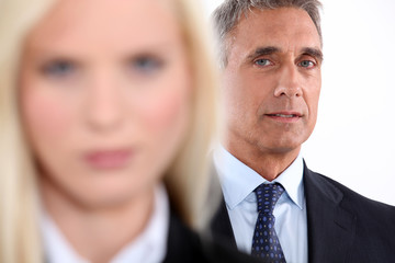 Male executive with female colleague out of focus