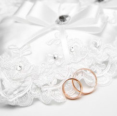Wedding gold rings on a white pillow