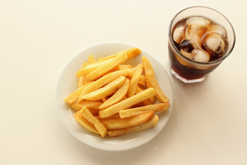Fried Potatoes on plate and glass of cola