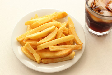 Fried Potatoes on plate and glass of cola