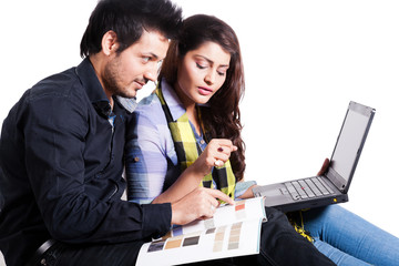 happy young couple using laptop isolated on white