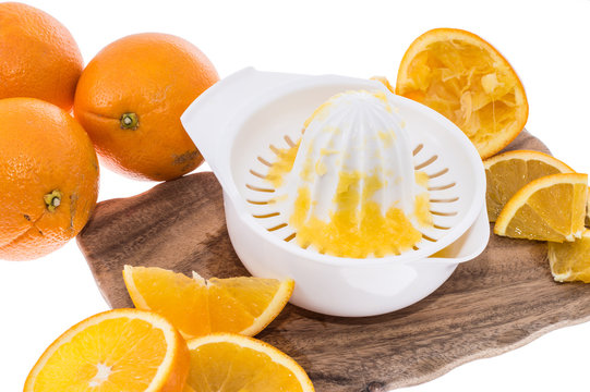 Squeezer with fresh Oranges on white