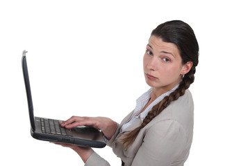 Jaded woman holding a laptop