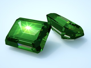 two emerald precious stone with reflection
