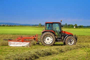 Naklejka premium Tractor with rotary rakes