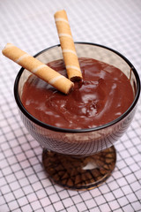 Chocolate pudding with waffle rolls