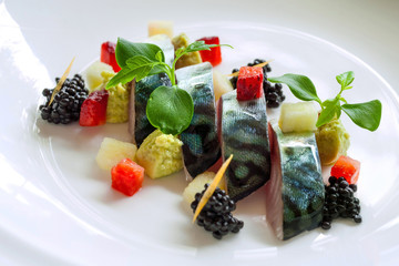 Close up of grilled mackerel fish with blackberries.