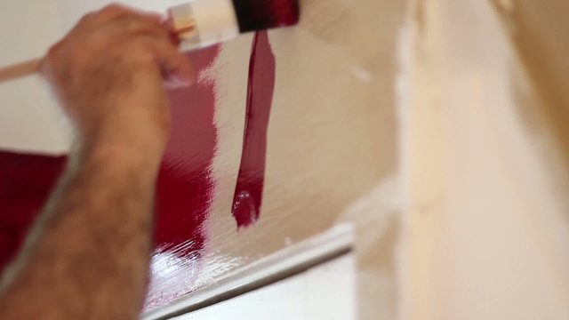 Painter - painting door frame red - time lapse