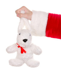 Santa Claus hand holding toy rabbit isolated on white