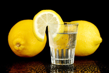 shot of tequila isolated on black background close-up