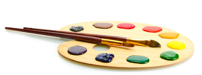 wooden art palette with  paint and brushes.isolated on white