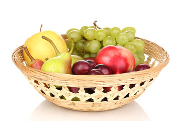 Mix of ripe sweet fruits and berries in basket isolated on