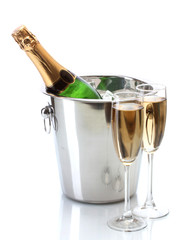 Champagne bottle in bucket with ice and glasses of champagne, © Africa Studio