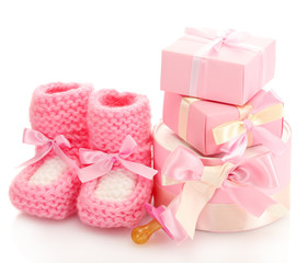 pink baby boots,  pacifier and gifts isolated on white