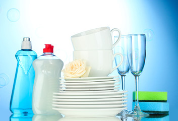 empty clean plates, glasses and cups with dishwashing liquid