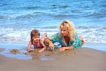 mother with daughter on beach