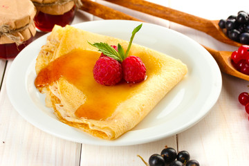 Delicious pancake with berries and honey