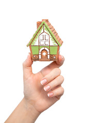 woman's hand holding a house