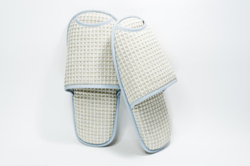 Pair of house slippers with reflection on white background