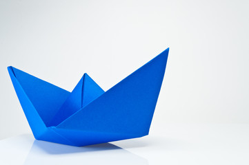 Close up origami paper ship on white background.