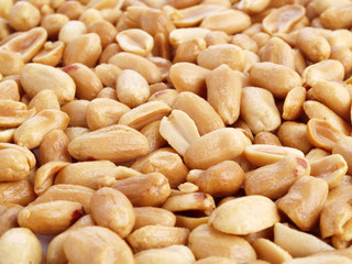 Close up of fried, peeled and salted peanuts.