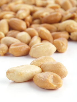Close up of fried, peeled and salted peanuts.