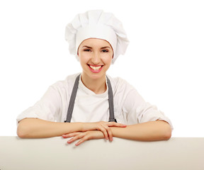 Happy woman cook or baker holding over paper sign billboard.