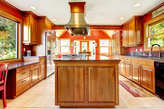 Large red luxury kitchen with wood and tiles.