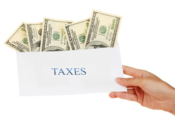 Woman's hand holding an envelope with money on white background