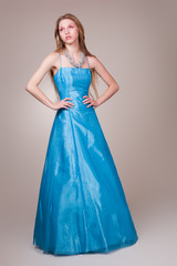 Beautiful young woman wearing a sexy blue evening dress