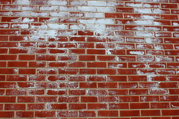 Old red brick wall with white paint splatter