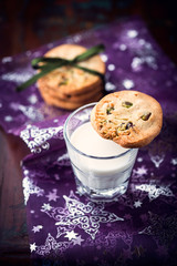 Butter cookies with pistachios on a glass of milk