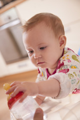 Baby taking the bottle of water