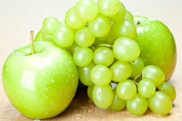 Green apples and grapes on the table