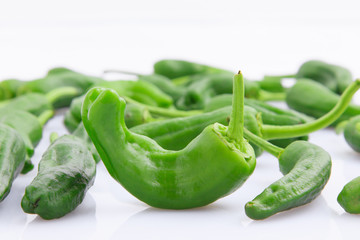 Green peppers on white background