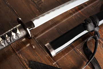 Katana Sword with Black Scabbard on Wood