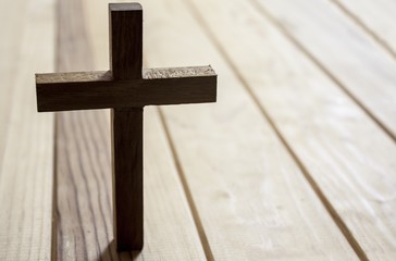 cross on wood table background