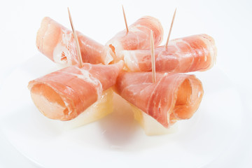 Jamon  ham with melon plate isolated on white