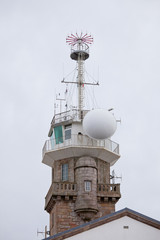 Fototapeta na wymiar Old stone lighthouse with modern equipment