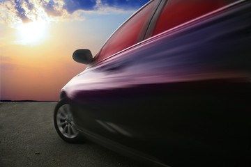 Fototapeta na wymiar moving car against sunset