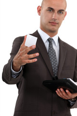 Man in suit giving business card