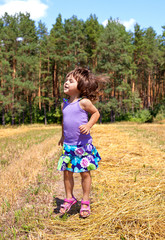 Little girl jumping in a meadow