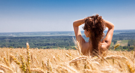 Young happy woman in wheat field