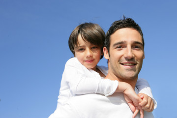 little boy on his father's back