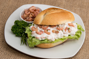 Shrimps on a roll (wooden background)