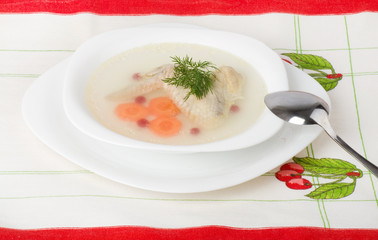 Tasty chicken clear soup with hen wing in plate
