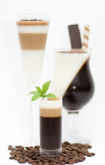 Tasty dessert with coffee beans on white background